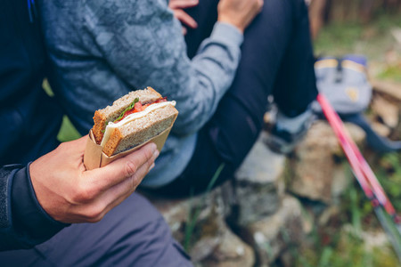 Sandwich that a couple is going to eat doing trekking