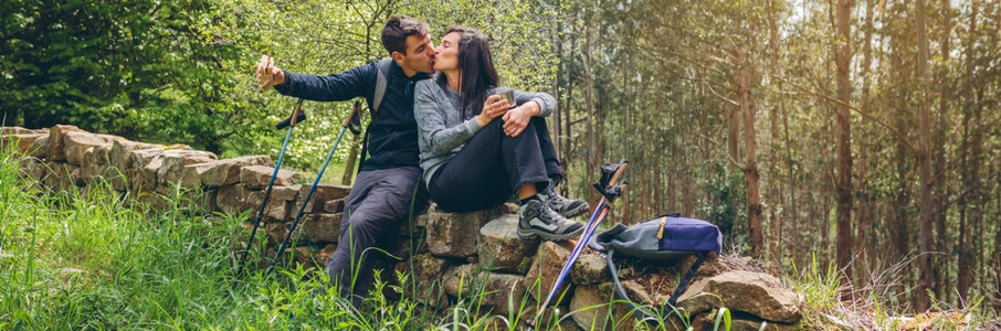 Couple kissing while making a break to do trekking