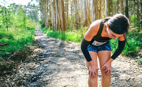 Female athlete pausing at a trail competition