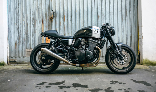 Customized motorcycle in front of garage door