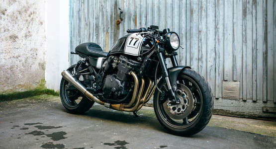 Customized motorcycle in front of garage door