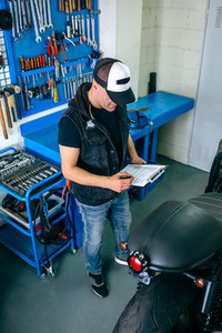 Mechanic checking motorcycle