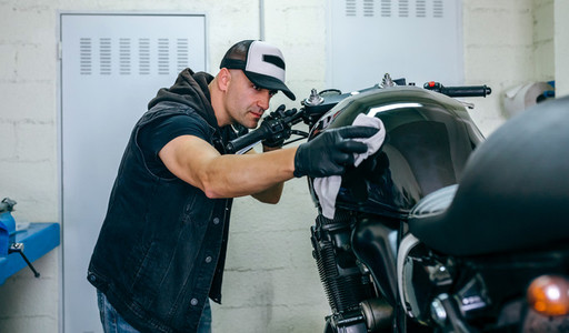 Mechanic cleaning a motorcycle