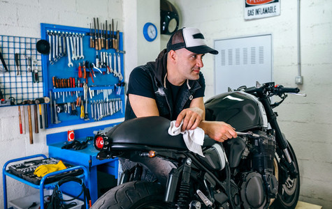 Mechanic posing with a motorcycle