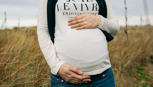Pregnant woman caressing her tummy