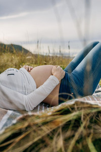 Pregnant woman caressing her tummy sleeping