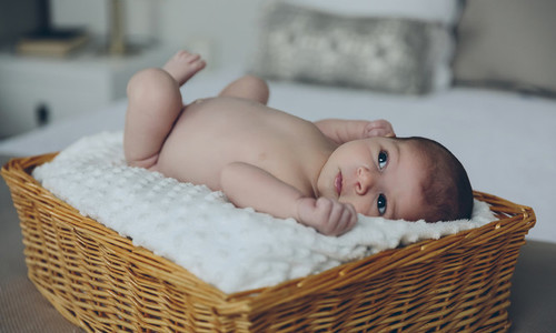 Baby lying in a wicker basket