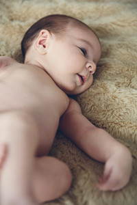 Newborn baby awake on a blanket