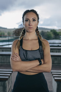 Sportswoman posing arms crossed