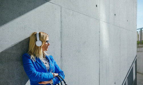 Businesswoman with headphones posing