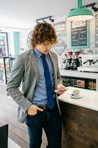 Businessman looking mobile in a cafe