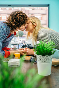 Couple kissing in a cafe