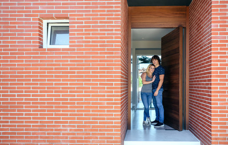Couple at the entrance of their house
