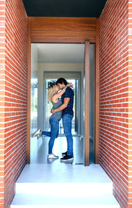 Couple kissing at the entrance
