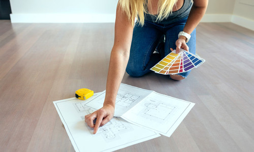 Young woman looking house plans