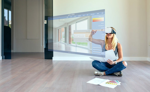 Woman decorating with virtual reality glasses