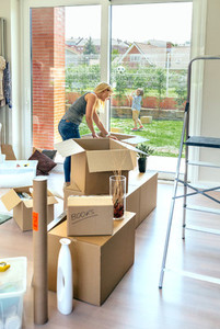 Woman unpacking moving boxes