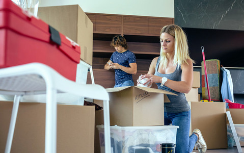 Woman unpacking moving boxes