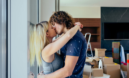 Couple kissing in the living room