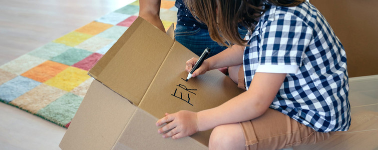 Boy writing in a moving box