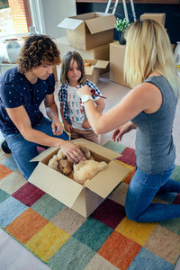 Family preparing moving toy box