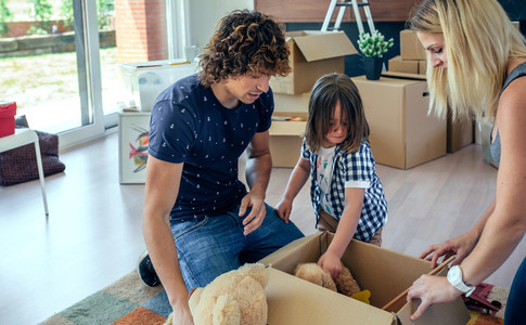 Family preparing moving toy box