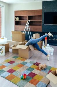 Woman inside a box preparing the move