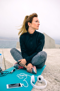 Woman sitting with sport accessories