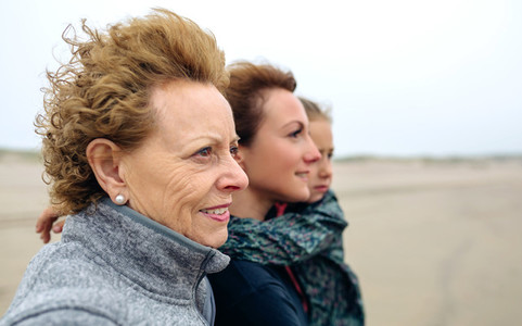 Three generations female looking at sea