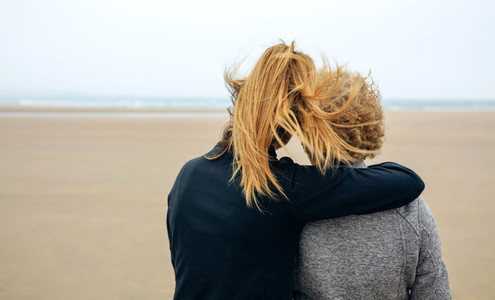 Back view of senior and young woman looking at sea