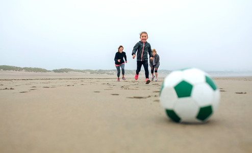 Soccer ball with three running people