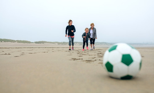 Soccer ball with three running people