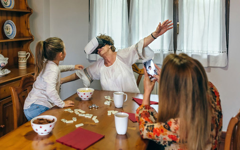 Senior woman using virtual reality glasses