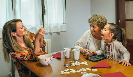 Grandmother and granddaughter play a game on the tablet