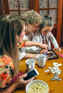 Grandmother and granddaughter play a game on the tablet