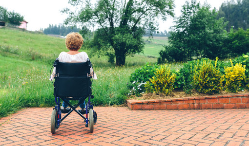 Unrecognizable senior woman in a wheelchair