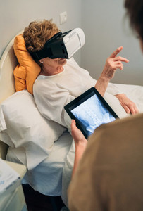 Older patient using virtual reality glasses
