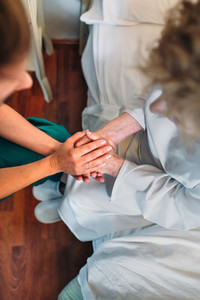 Doctor giving encouragement to elderly patient