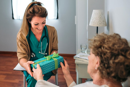 Senior patient giving a gift to her doctor