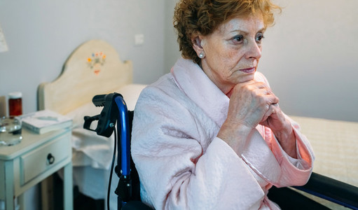 Senior woman in a wheelchair alone