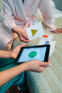 Female doctor showing geometric shapes to elderly patient