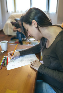 Young woman coloring mandalas