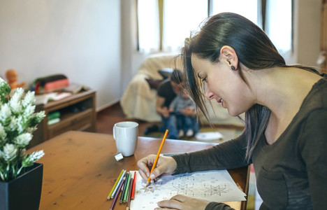 Young woman coloring mandalas