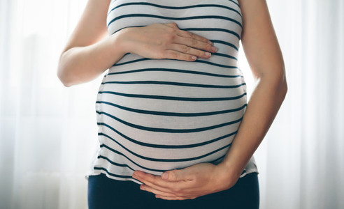Pregnant woman holding her tummy