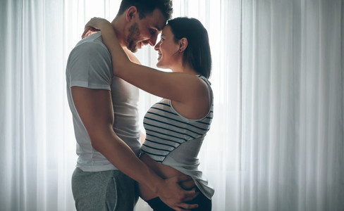 Man embracing his pregnant woman