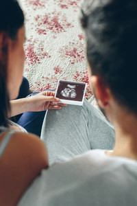 Couple looking at ultrasound of their baby