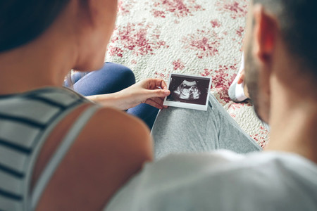 Couple looking at ultrasound of their baby
