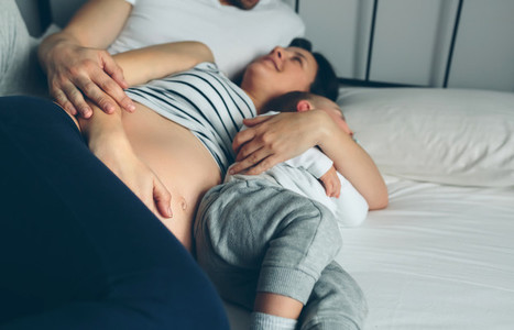 Pregnant with man and boy in bed