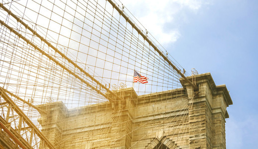 Towers and American flag over Brooklyn Bridge