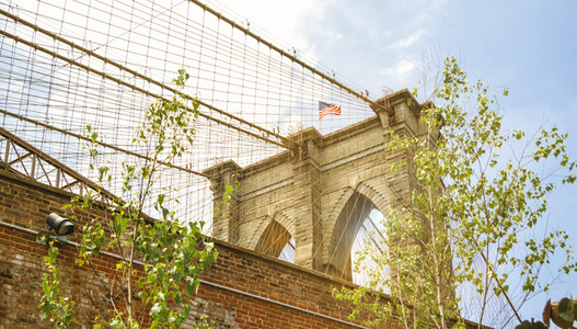 Towers and American flag over Brooklyn Bridge